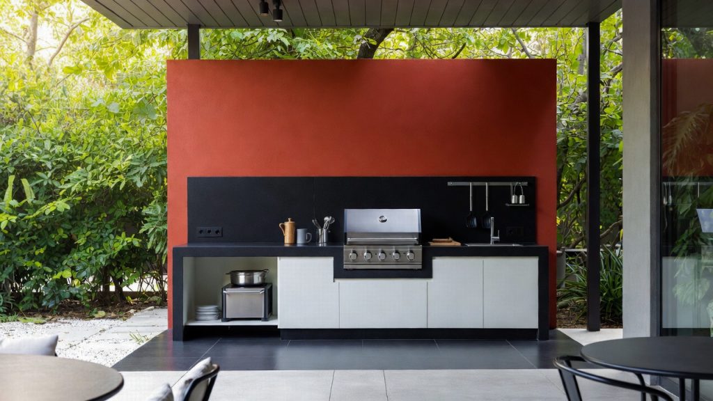 Compact white outdoor kitchen with red wall — ConstanKitchen client project